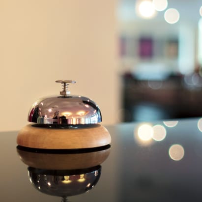 sales training services as a front desk bell on a glass table